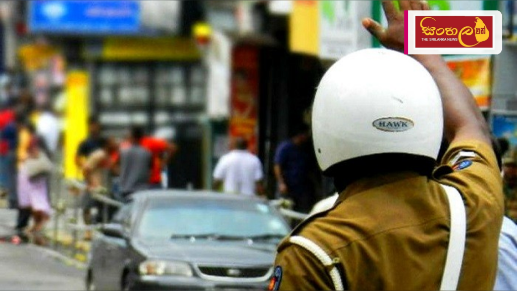Headline: කොළඹ මැරතන් තරගය නිසා හෙට උදෑසන විශේෂ රථවාහන සැලැස්මක් Intended image subject: Colombo city traffic police officer Story summary: කොළඹ මැරතන් 2026 තරගාවලිය පැවැත්වීම හේතු